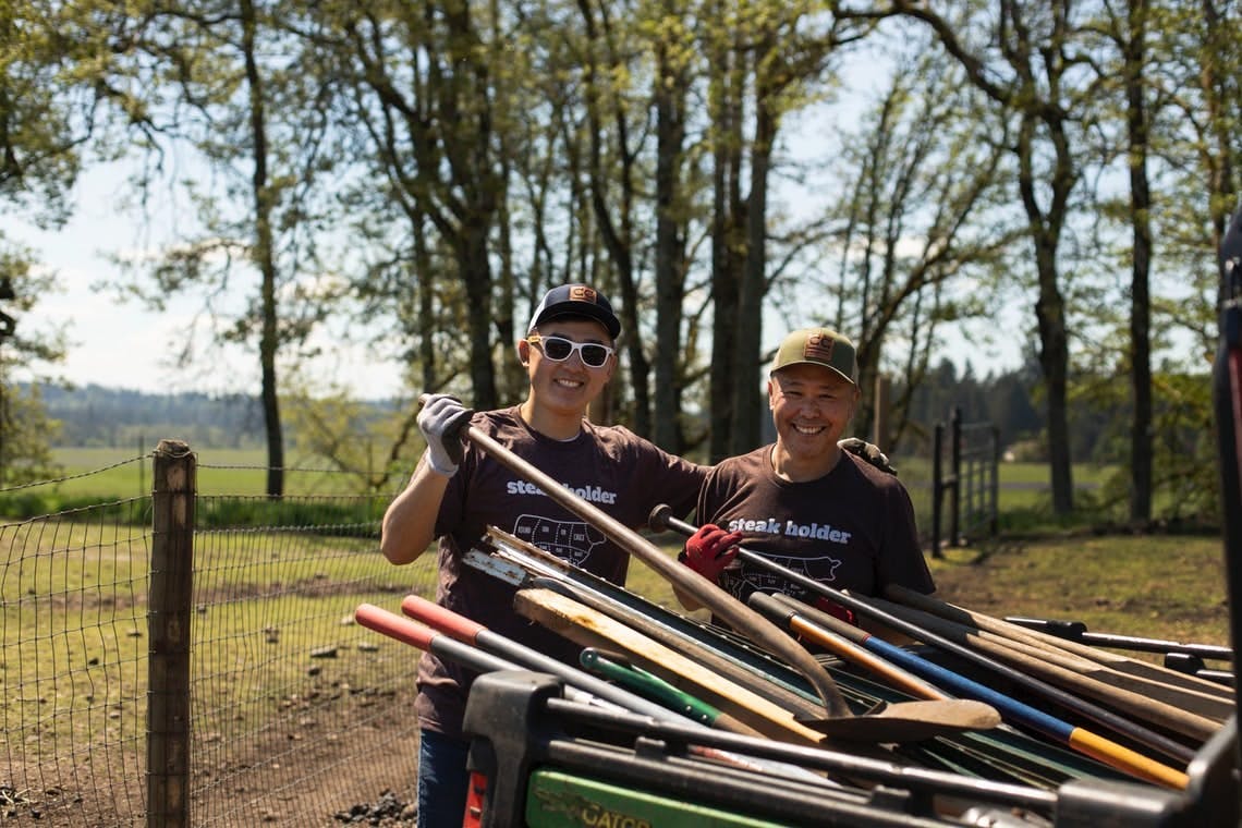 Crowd Cow "steak holders" doing farm work.